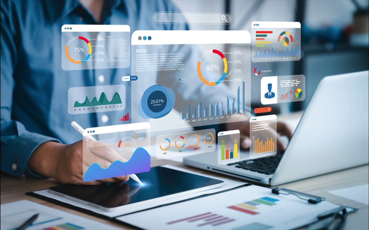 An analyst uses a computer and a dashboard for business data analysis.